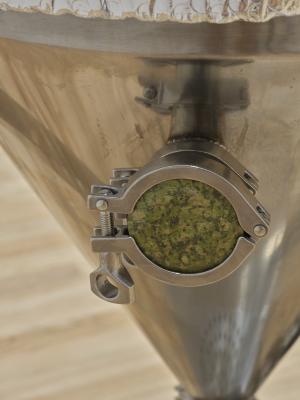 A detail shot of a customized unakite tri-clover cap on a stainless steel brewing unitank.