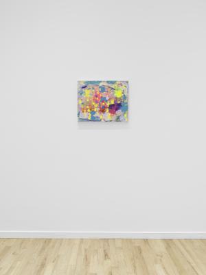 A small abstract painting hangs on a white wall. Fluorescent blue, yellow, and pink shapes are layered over a  canvas surface washed with pink and blue pigment.