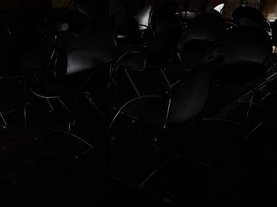 Black chairs facing in different directions take up the entirety of the frame.