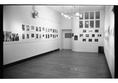 Photographic prints of jazz musicians are hung in rows on the gallery walls.