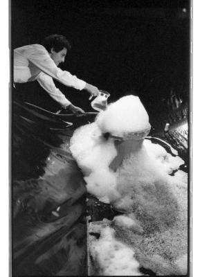 Alzek Misheff pours a pitcher of liquid onto a garbage can that is overflowing with bubbles.